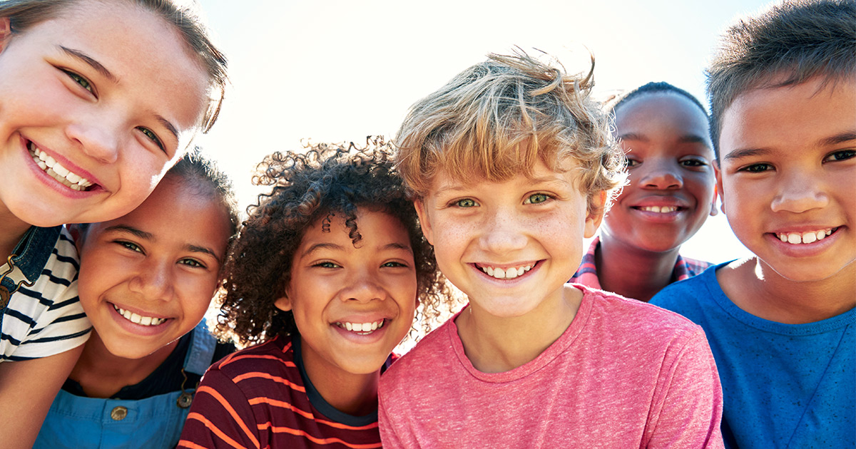 a group of kids together smiling